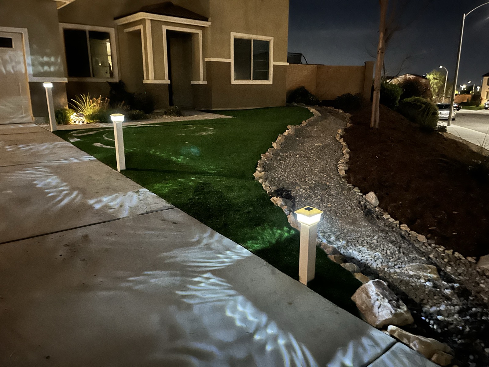 Front yard artificial turf with landscape lighting at night in Menifee, Inland Empire