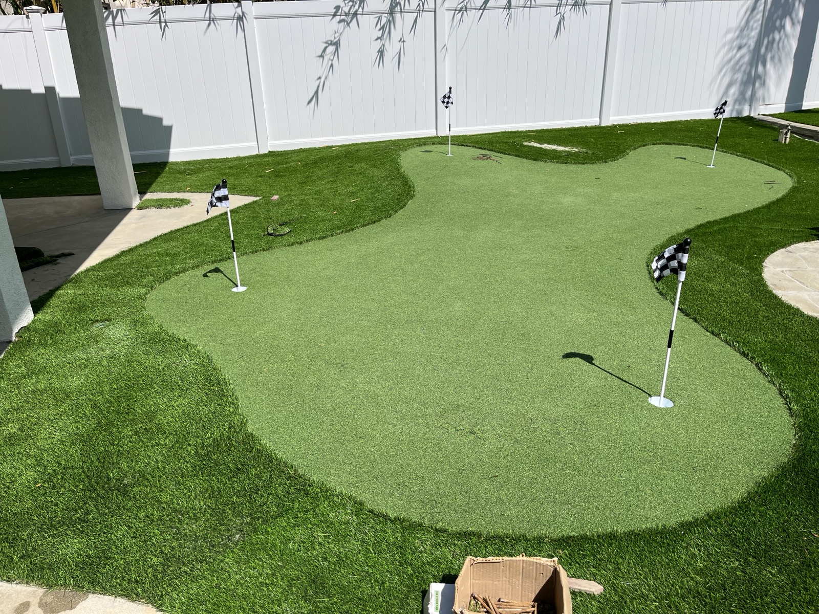 Custom putting green with flag pins installed in Hemet, Inland Empire