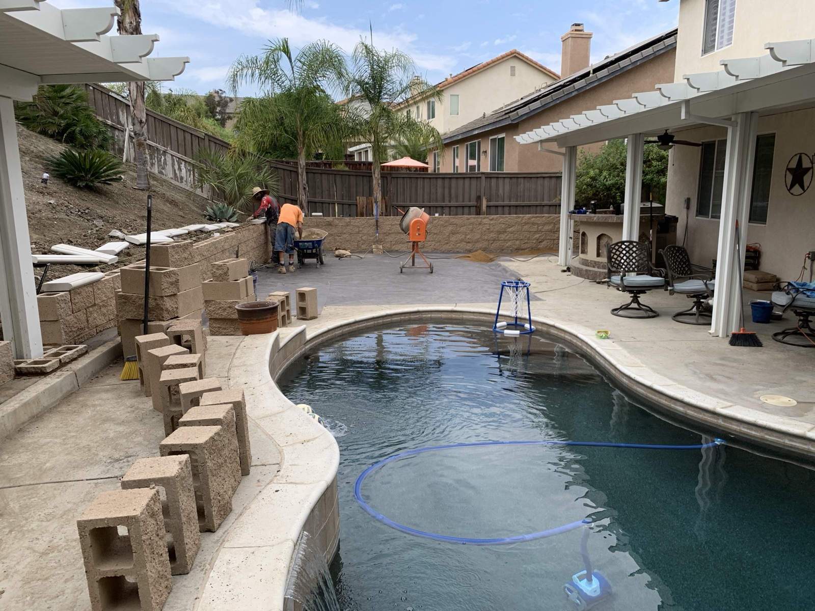 Pool area retaining wall construction with crew working in Murrieta, CA